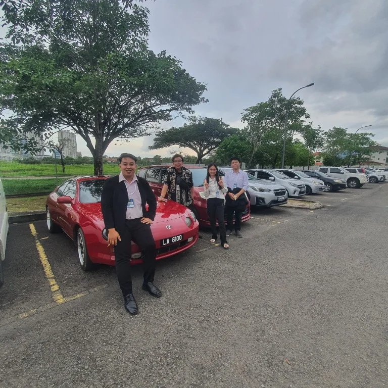 Jr Josuah with colleagues during an outdoor gathering